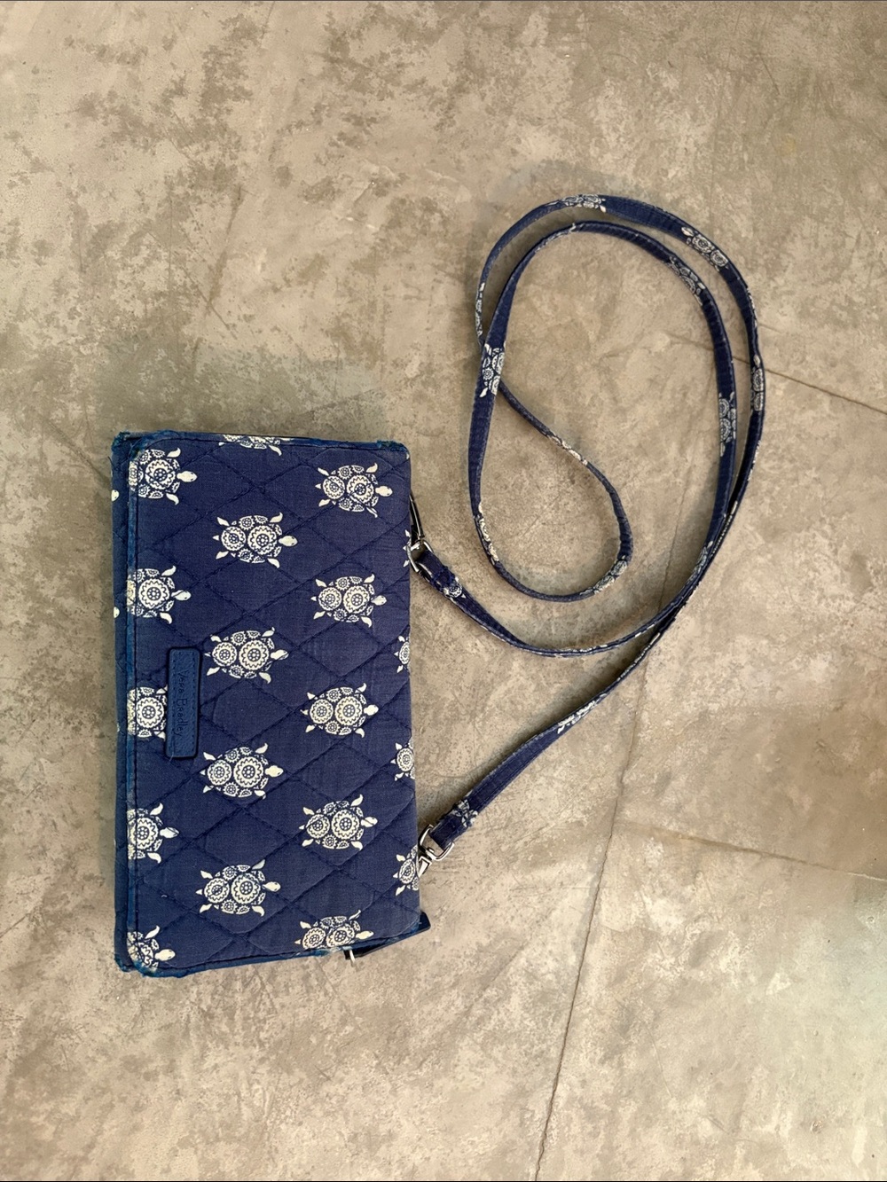 Vera Bradley RFID cross body wallet features a quilted  white sea turtle pattern